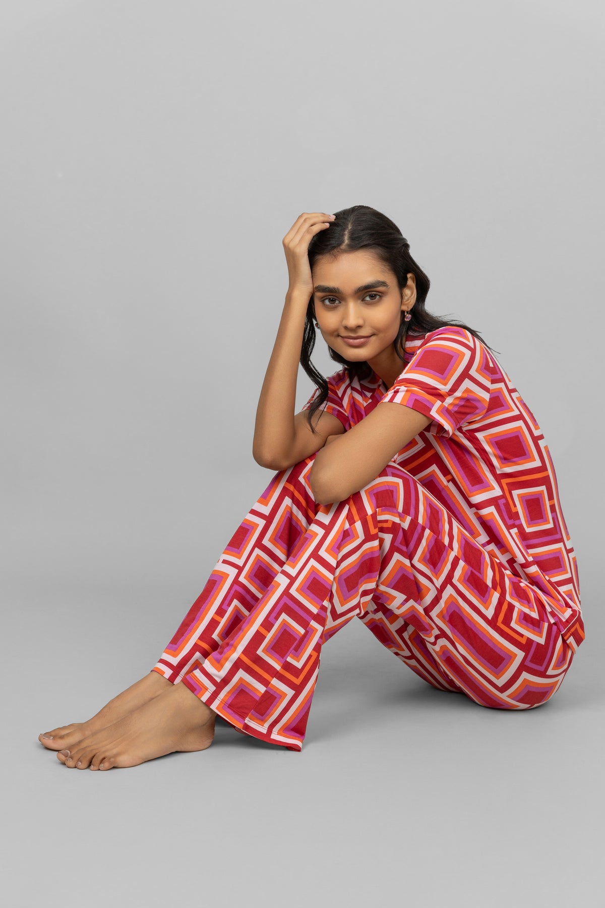 Model wearing red Zen pajamas with geometric patterns.