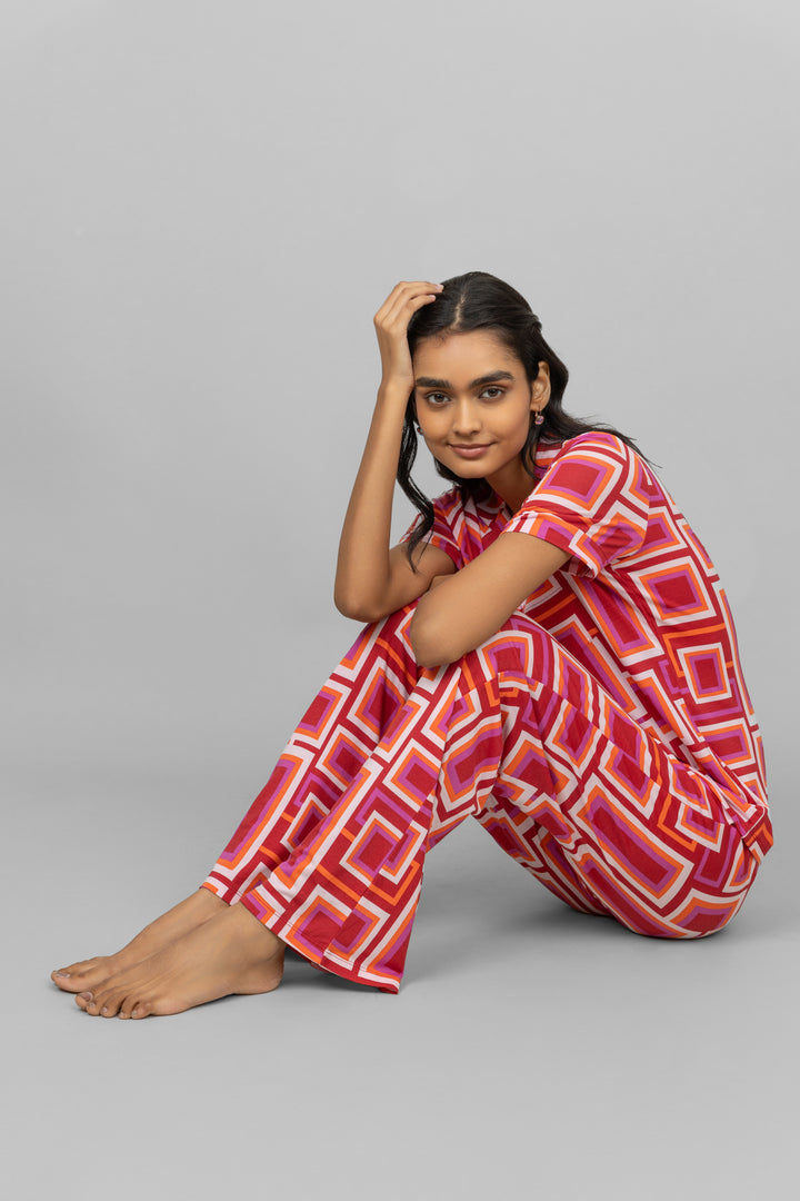 Model wearing red Zen pajamas with geometric patterns.