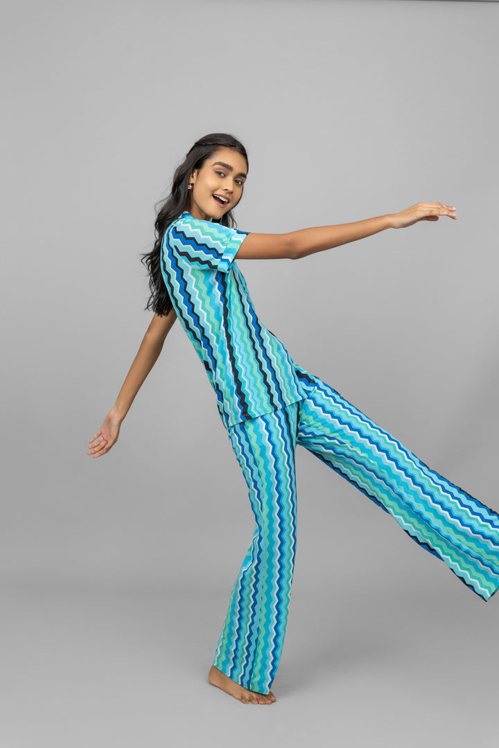 AquaWave Pajamas featuring stylish blue wavy patterns on model.