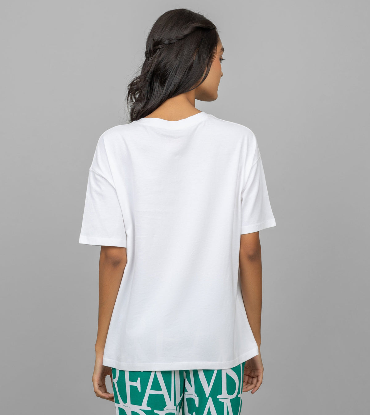 Back view of woman wearing white oversized lazy top.