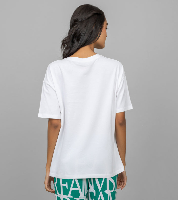 Back view of woman wearing white oversized lazy top.