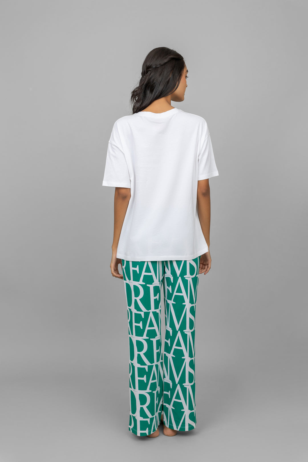 Woman modeling Dream Land Pajamas with playful print and relaxed fit.