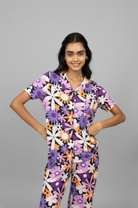 Floral half-sleeve button t-shirt model in colorful print.