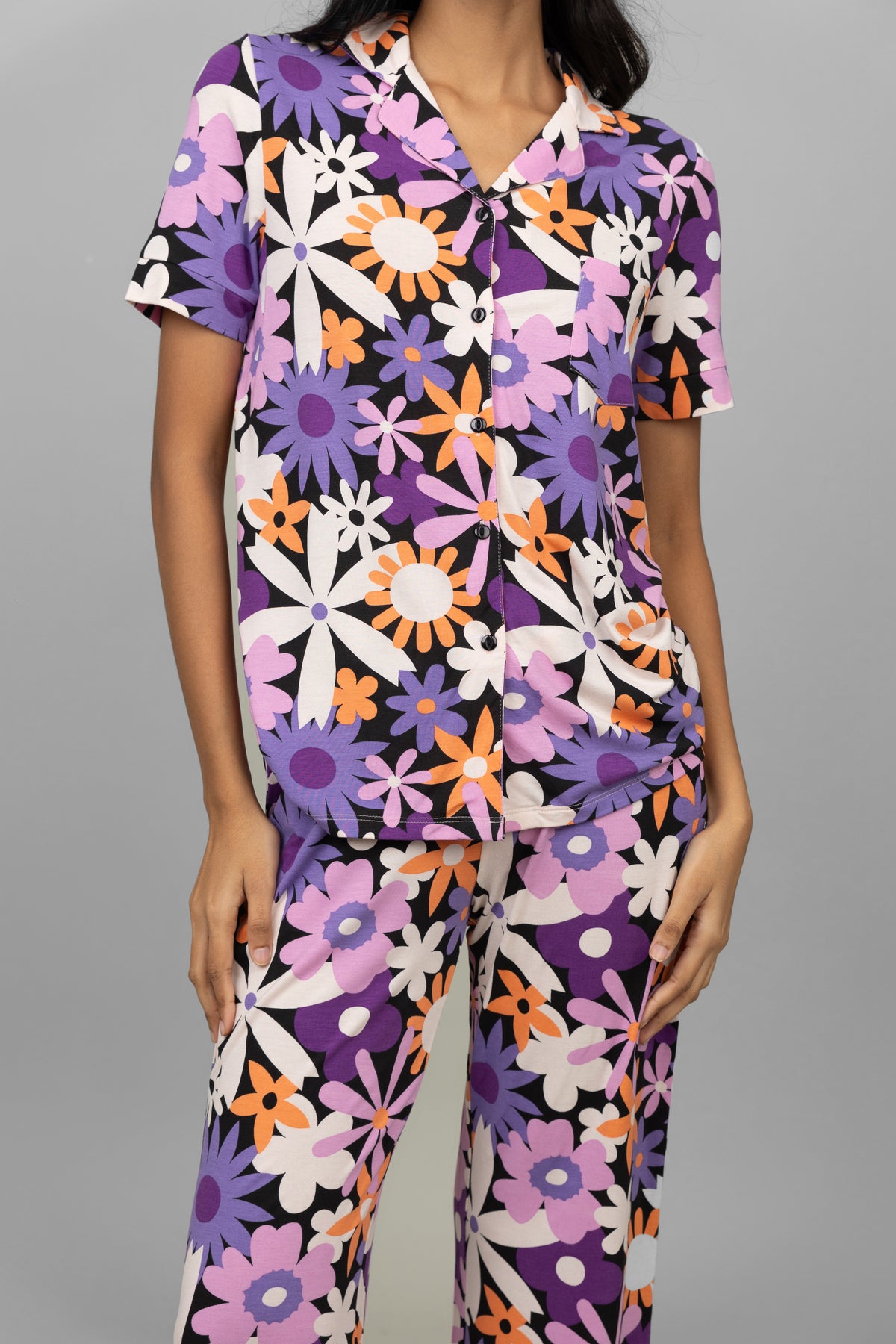Floral half-sleeve button t-shirt in colorful flower pattern.