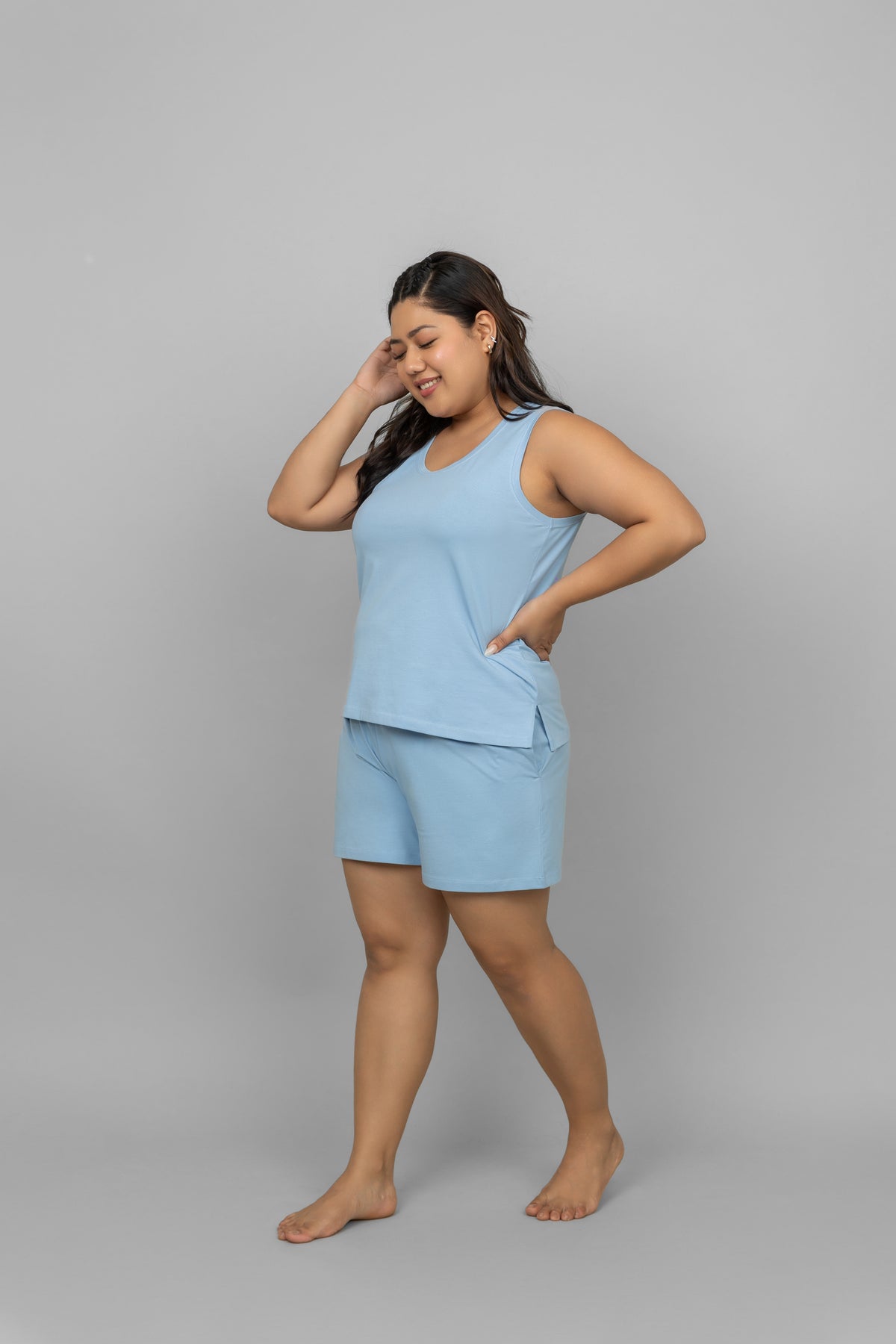 Blue cotton tank top model in comfortable shorts, stylish and relaxed look.