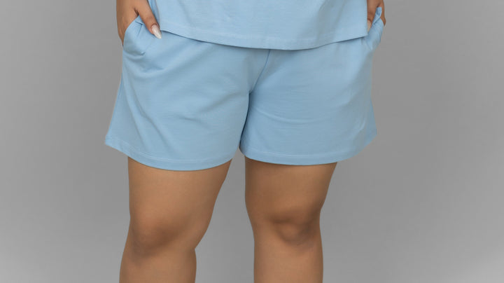Blue cotton lounge shorts with pockets for casual comfort.