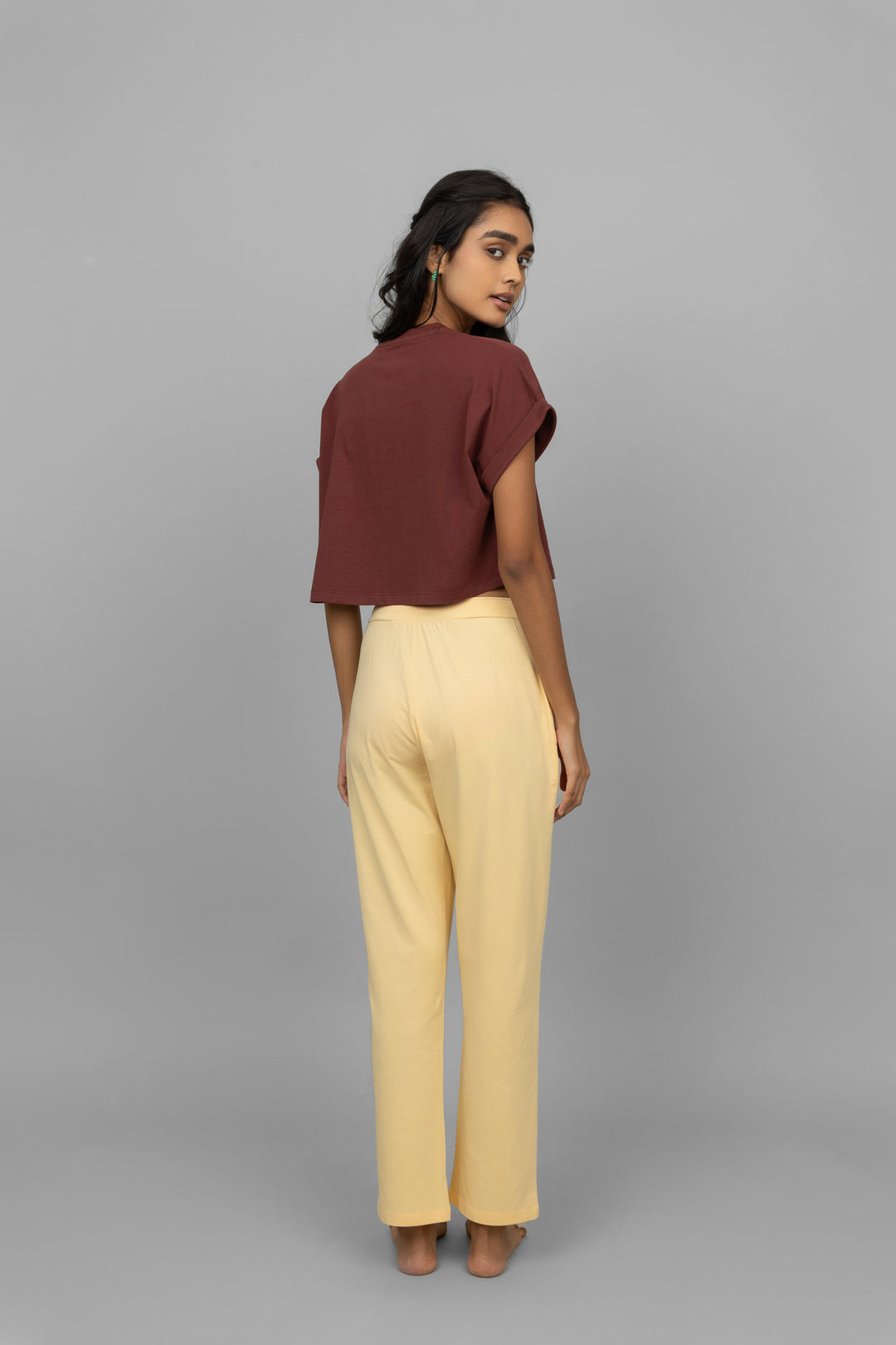 Model wearing yellow cotton lycra pants with a brown crop top.