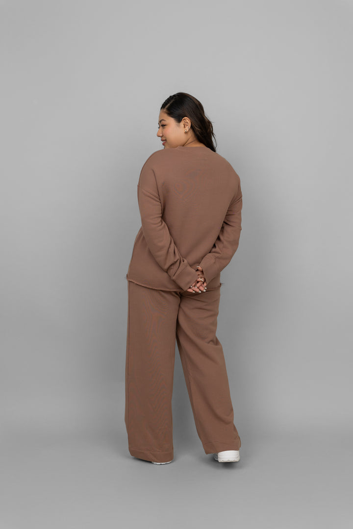 Brown terry ruched co-ord set model posing from the back.