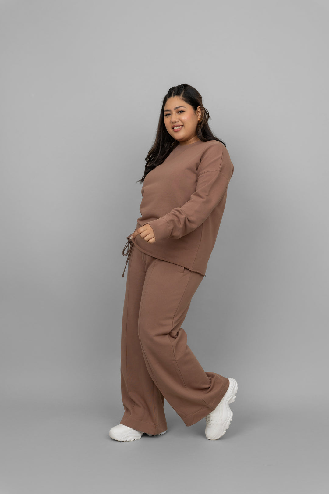 Brown terry ruched co-ord set model styled with white sneakers.