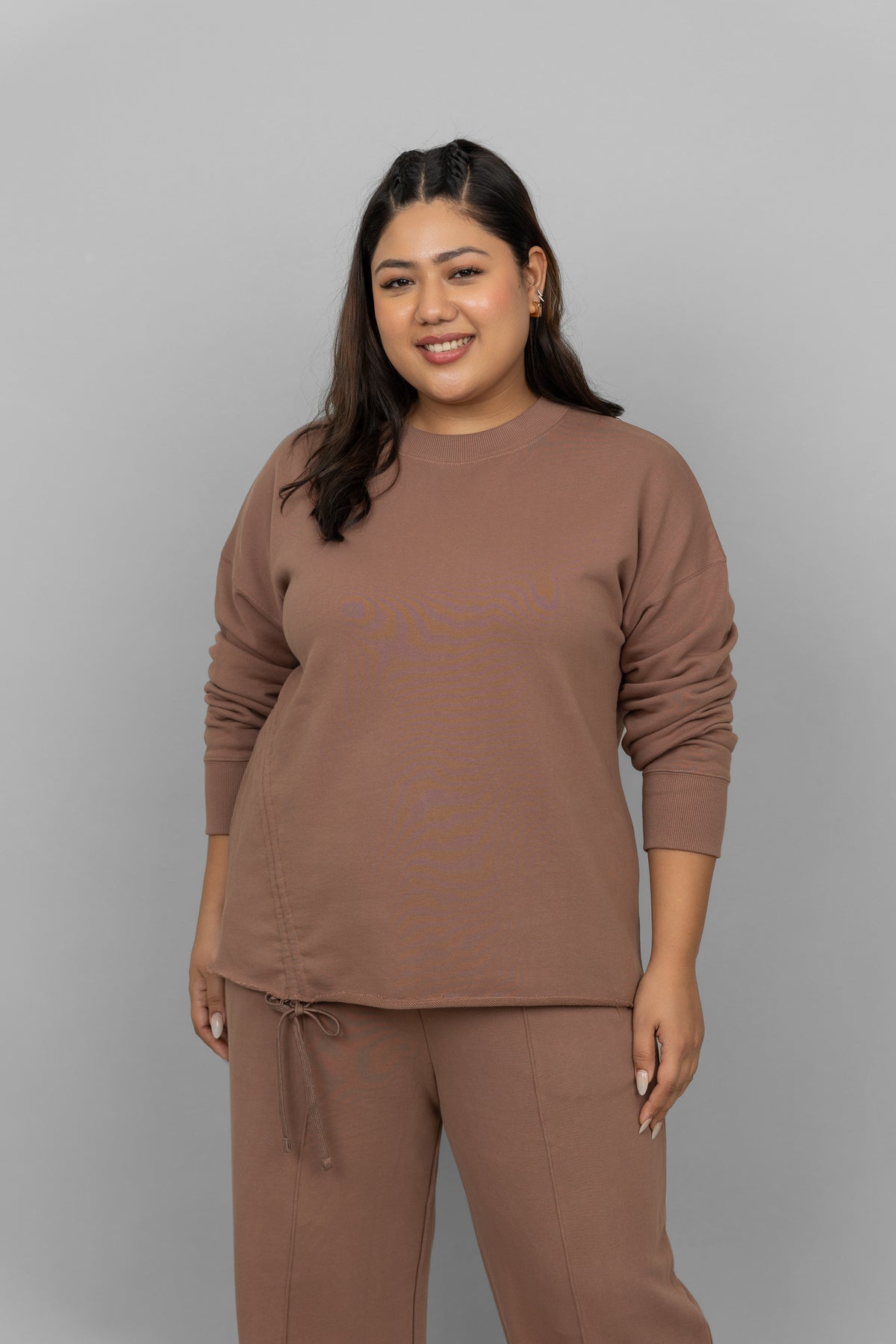 Brown cotton terry sweatshirt worn by a smiling model.