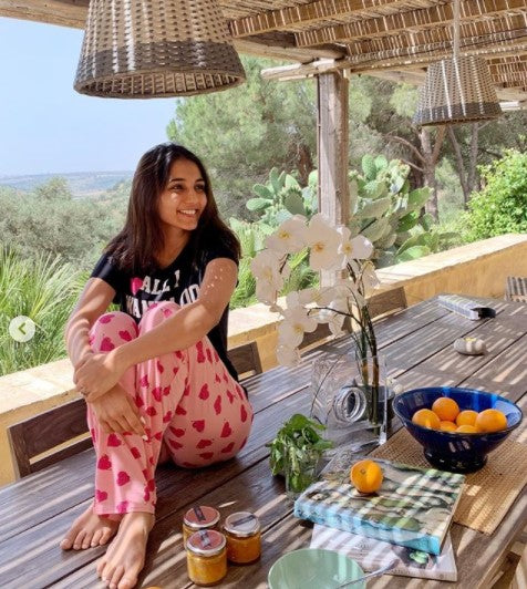 Nap Queen Pajama Set with a relaxed model in a sunny outdoor setting.