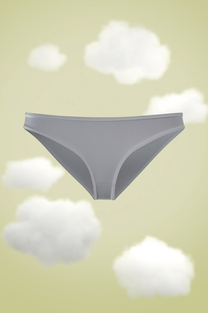 Supima Bikini Nessies in soft gray against a dreamy cloud backdrop.