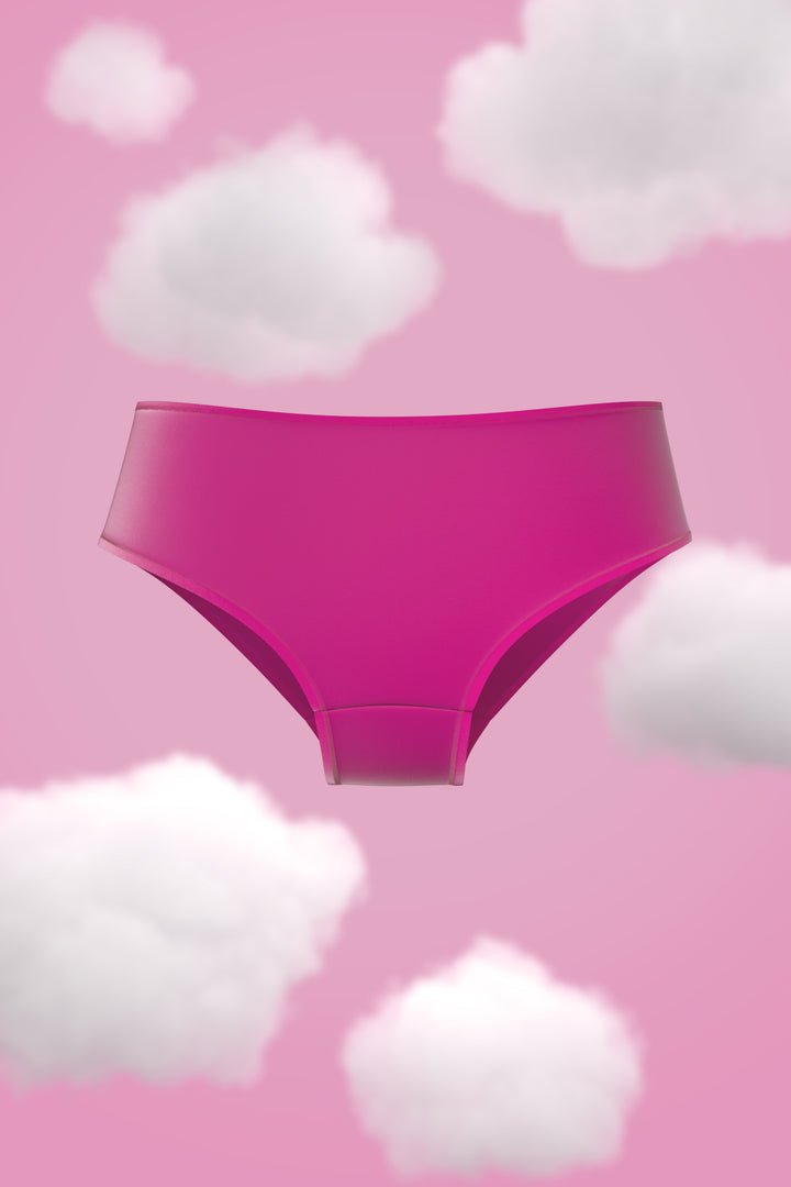 Supima Brief Nessies in vibrant pink against a cloud-filled pink background.