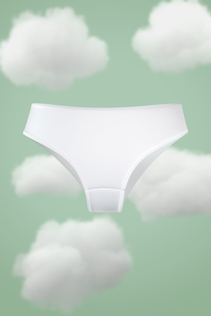Supima Hipster Nessies in white against a pastel cloud background.