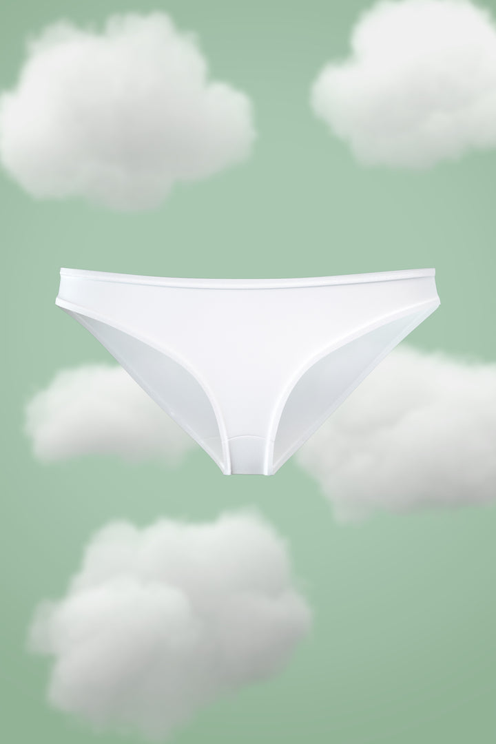Supima Bikini Nessies in white, set against a cloud background.