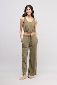 Olive Supima® drawstring co-ord set modeled by a smiling woman.