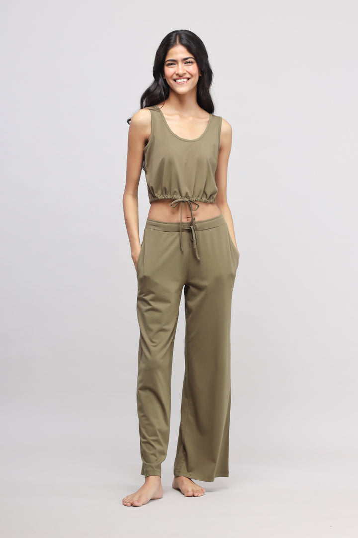 Olive Supima® drawstring co-ord set modeled by a smiling woman.