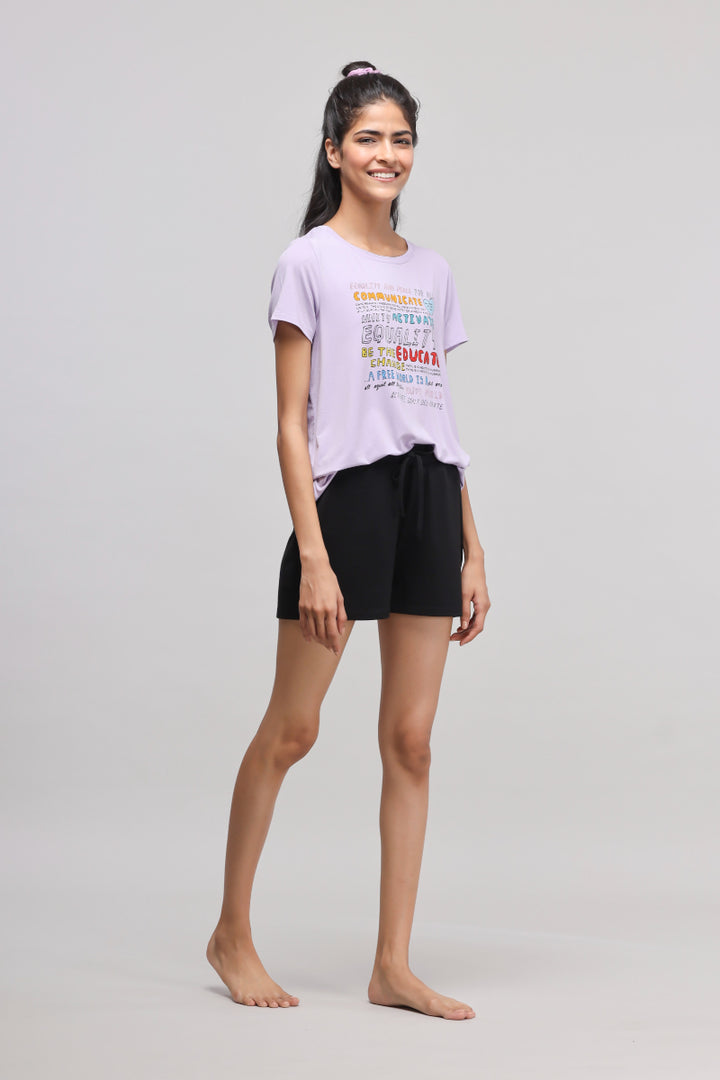 Model wearing stretchy black Supima® shorts with casual purple t-shirt.