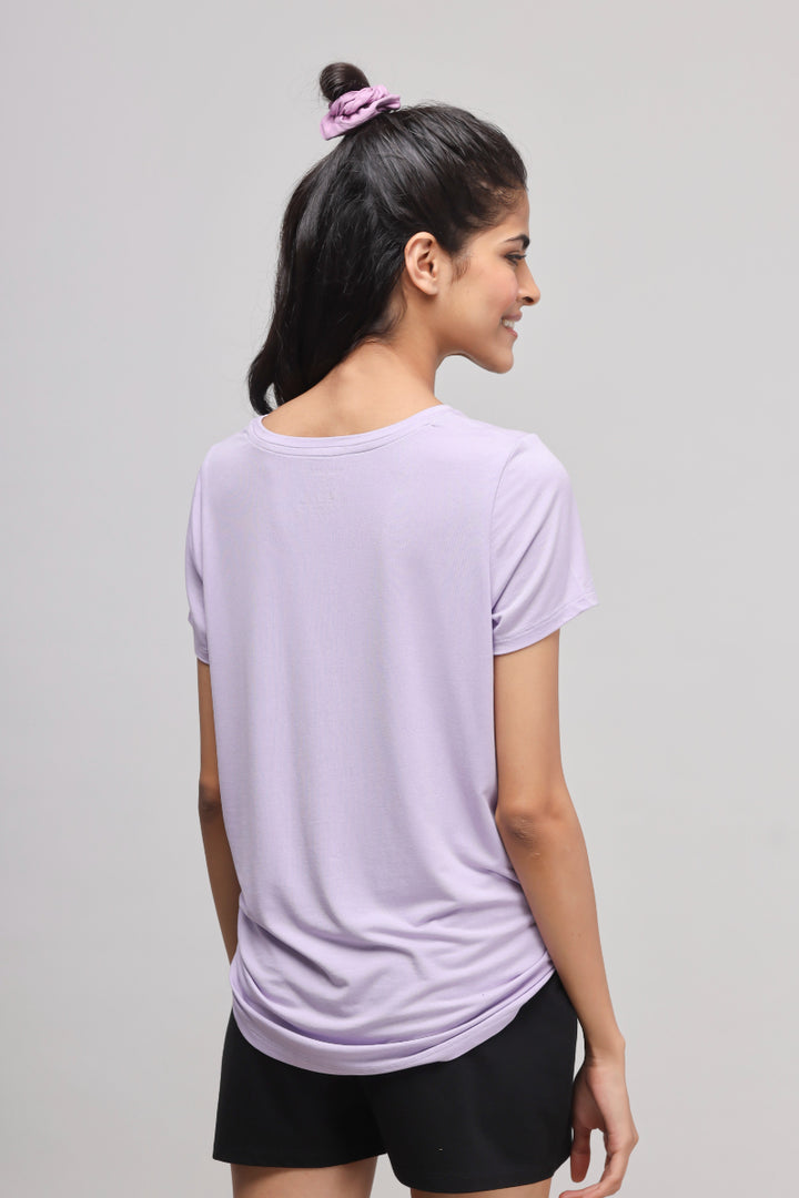 Model wearing lavender Equality Shorts Set from the back.