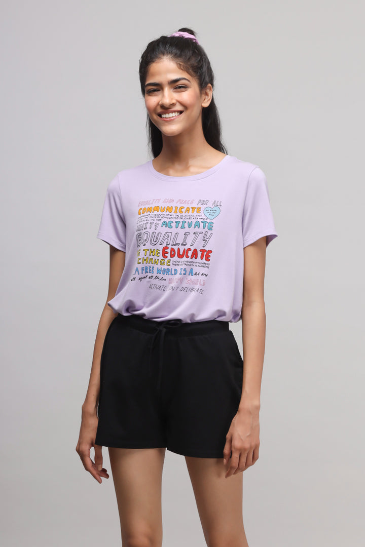 Woman wearing Equality Purple Top with positive graphic design.