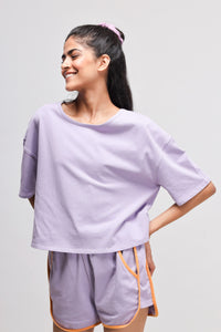 Boxy purple cotton top worn with matching shorts, casual and stylish.