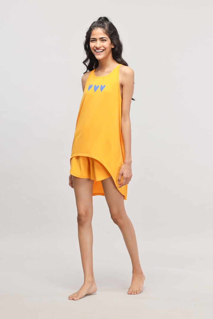 Model wearing a vibrant yellow Butterfly Shorts Set with blue hearts.