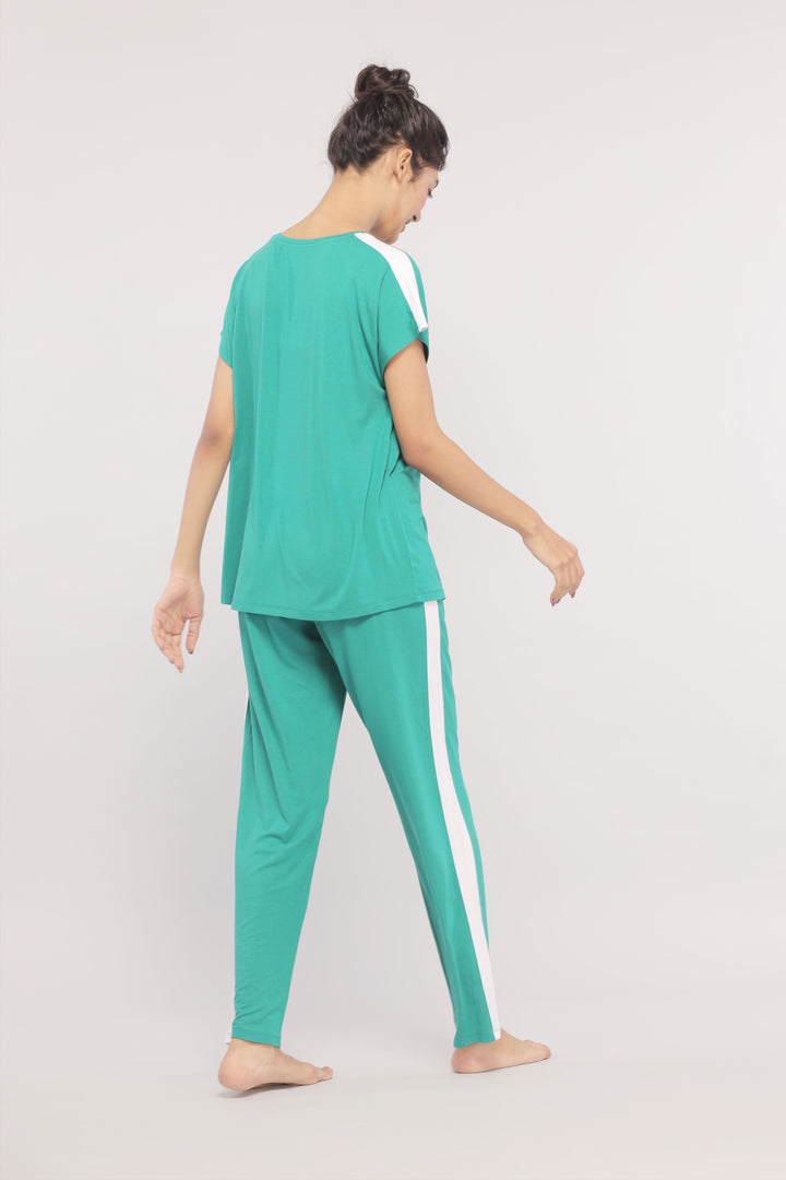 Cozy green pajama set with white stripes for relaxed comfort.