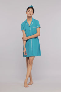 Short down button dress with white piping in vibrant turquoise color.