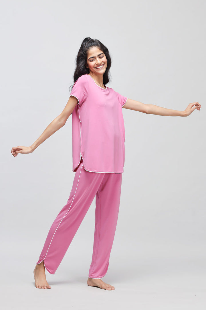 Rose pink pajama set with white piping for comfortable sleepwear.