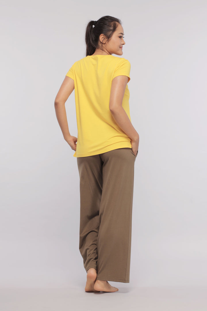 Model wearing military olive flared Supima® lounge pant with yellow top.