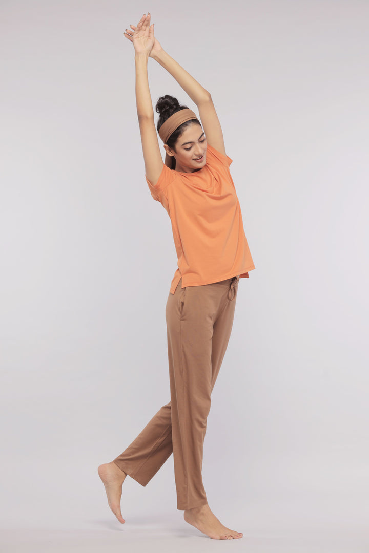 Model wearing Golden Ochre Supima® Round Neck Tee and relaxed pants.