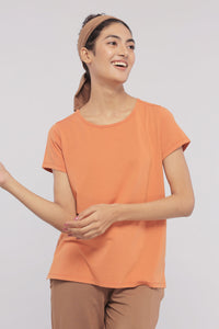 Golden Ochre Supima® Round Neck Tee on a smiling model.