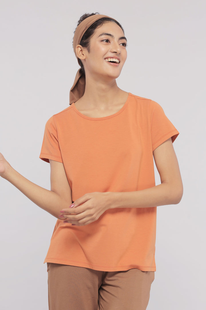 Model wearing Home Brown Flared Supima® Lounge Set in soft orange.