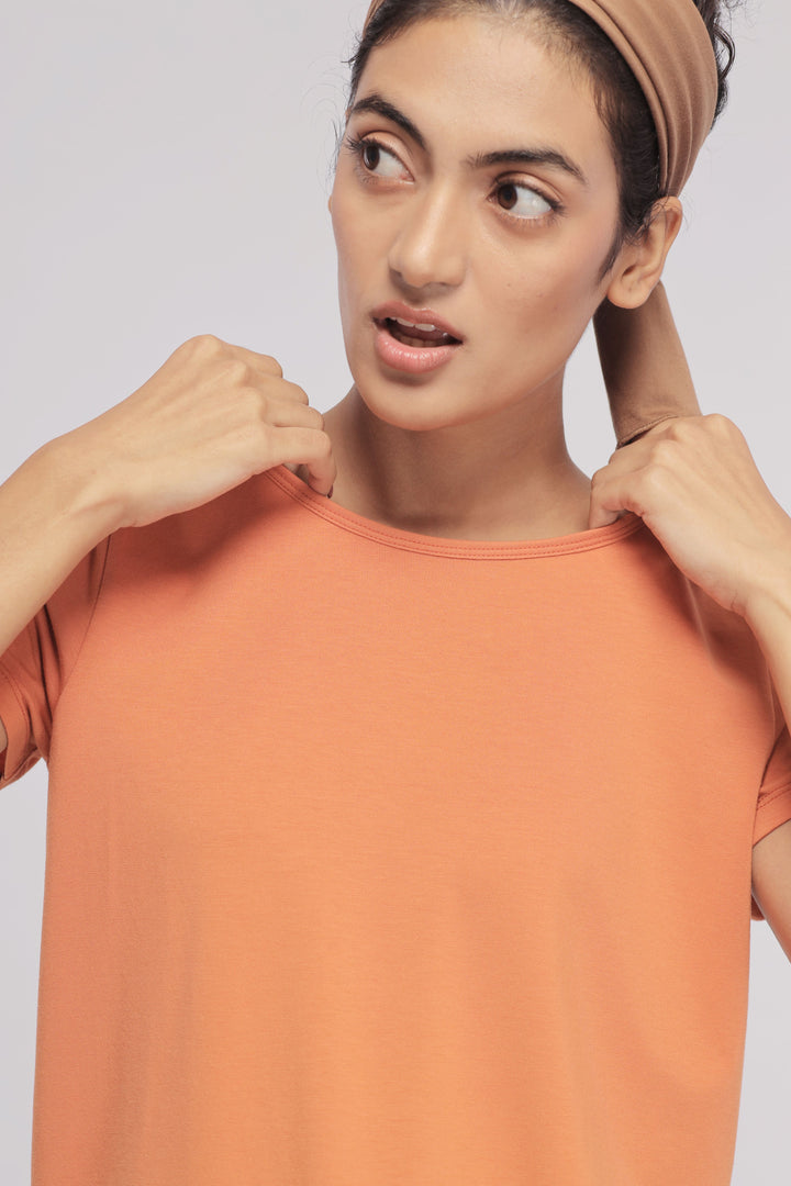 Golden Ochre Supima® Round Neck Tee on a model. Fashionable and cozy casual wear.