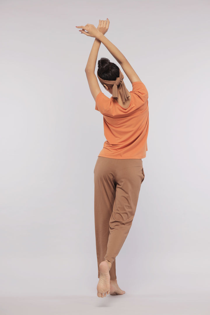 Home Brown Straight Supima® Lounge Set model stretching with stylish comfort.