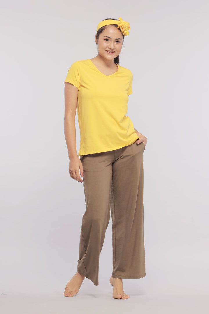 Model wearing Military Olive Flared Supima® Lounge Pant and yellow T-shirt.