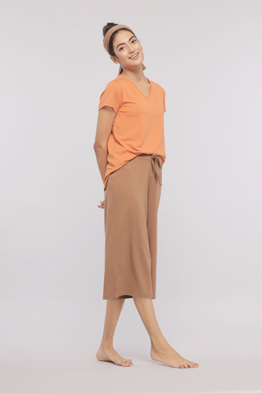 Golden Ochre Supima® V Neck Tee on model, paired with stylish pants.
