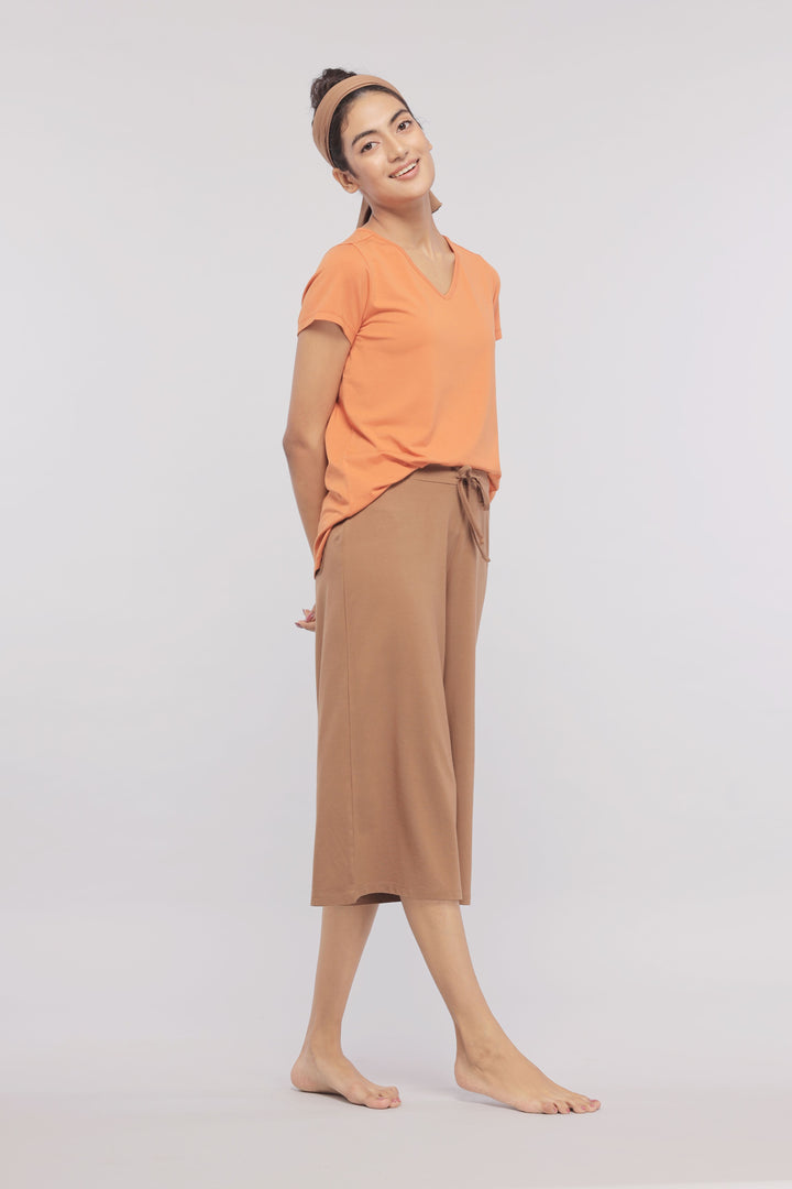 Golden Ochre Supima® V Neck Tee on model, paired with stylish pants.