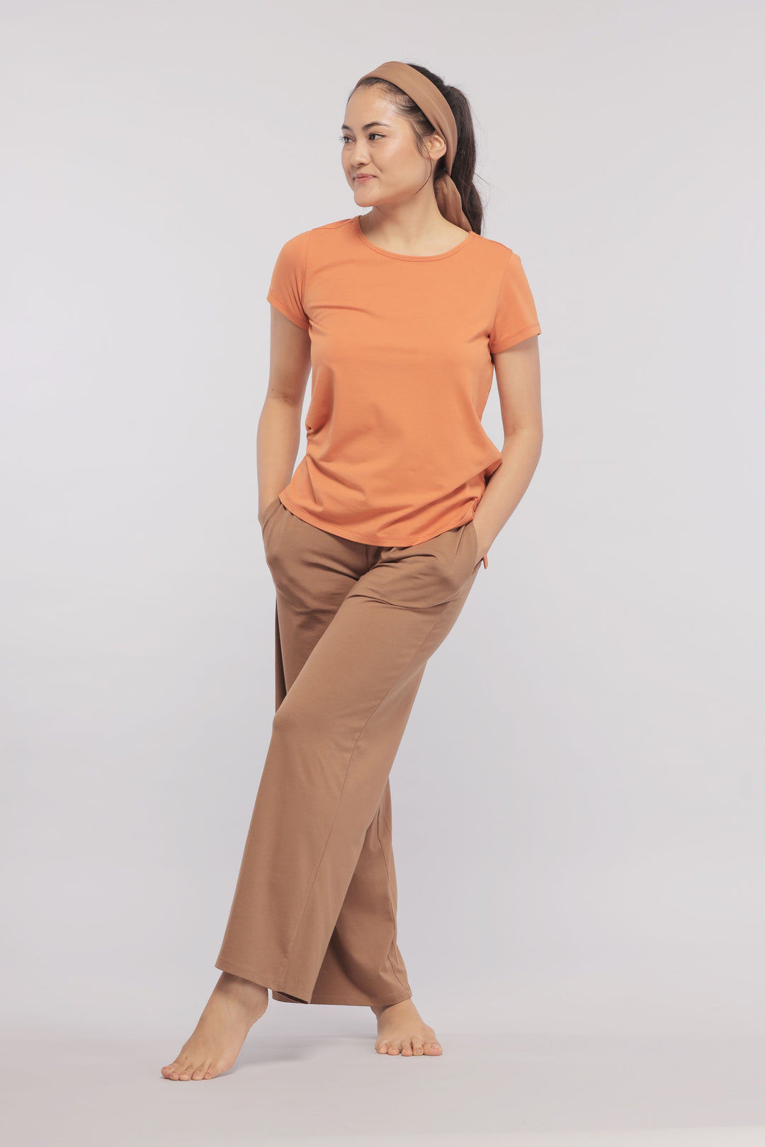 Home Brown Flared Supima® Lounge Set with model posing casually.
