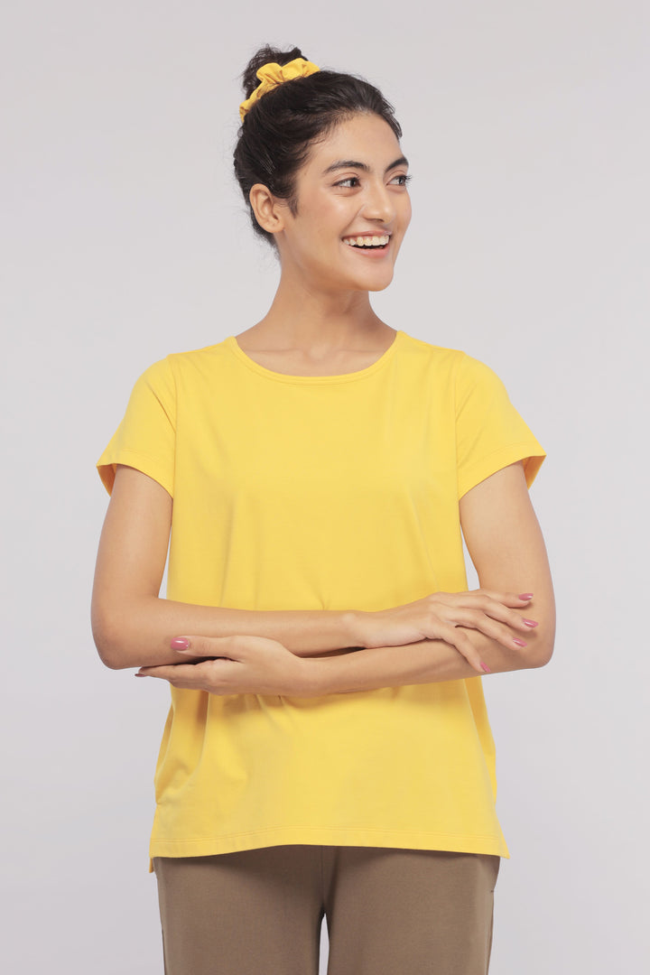 Cheerful woman in yellow top showcasing Military Olive Lounge Set.
