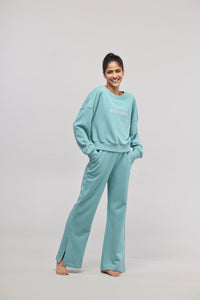 Smiling woman wearing Bonjour Terry Co-ord Set in turquoise color.