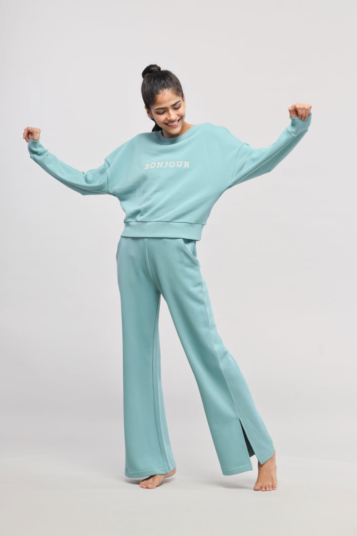 Model in mint green Bonjour Terry Co-ord Set, smiling and dancing.