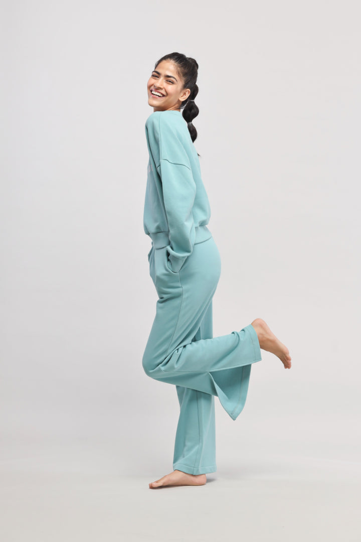 Smiling model wearing Bonjour Terry Co-ord Set in teal color.
