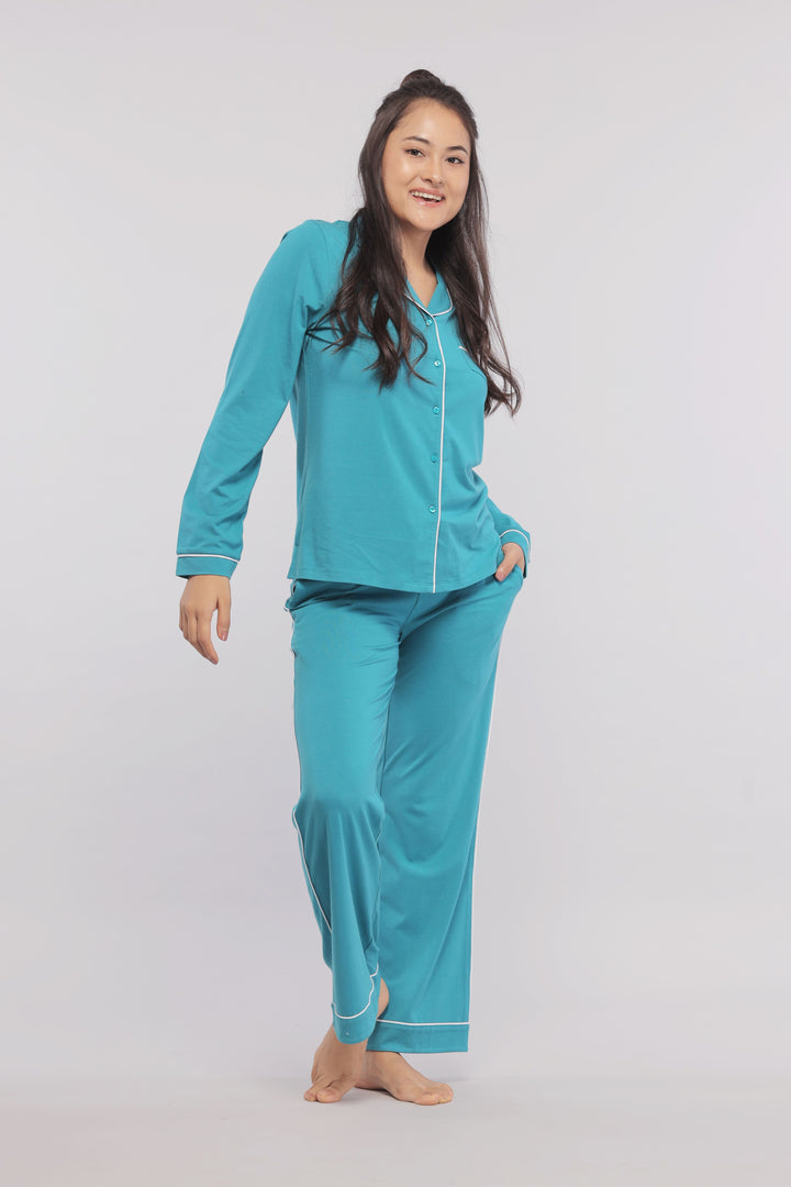 Teal pajamas with white piping, stylish and comfortable for lounging.