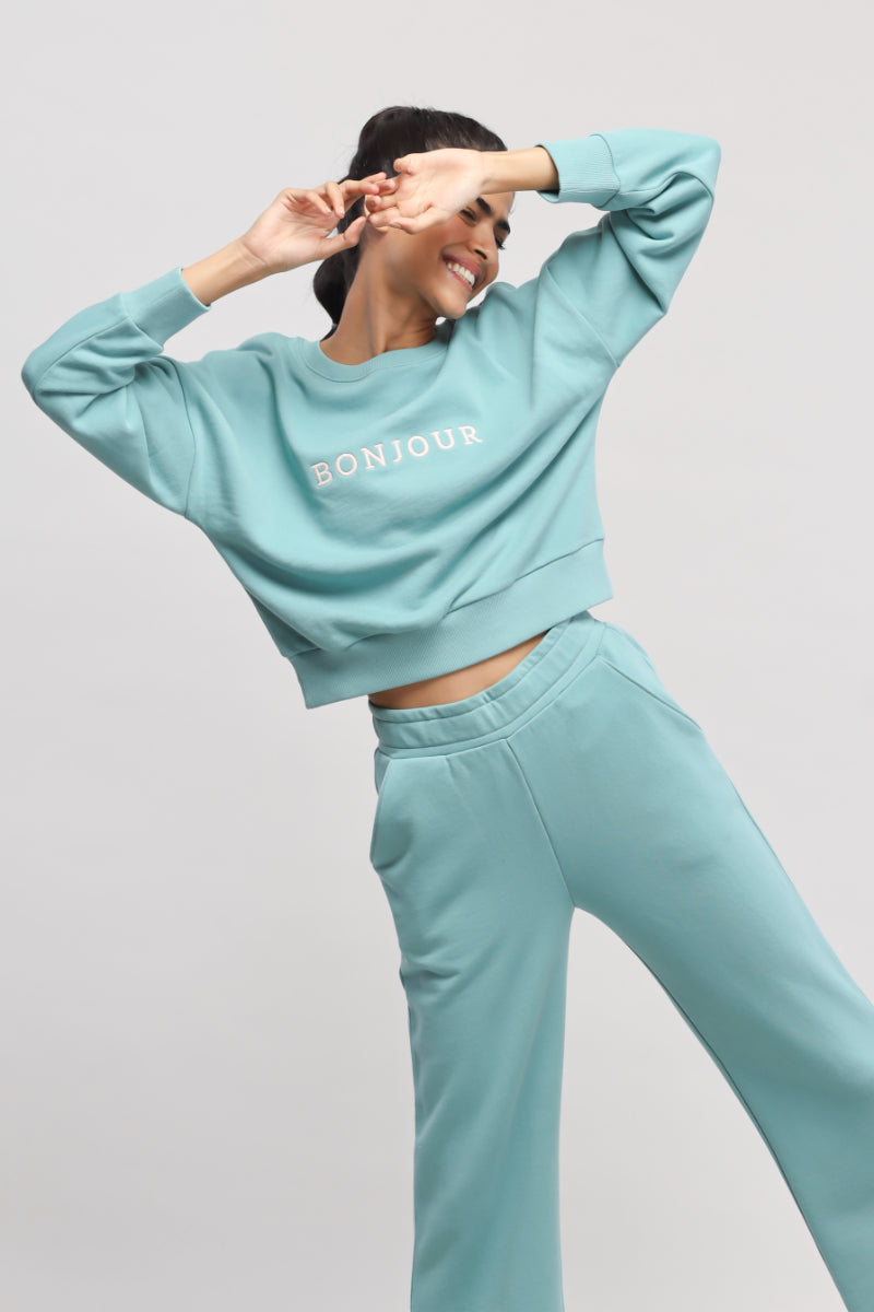 Model wearing light blue Bonjour Terry Sweatshirt with matching pants.