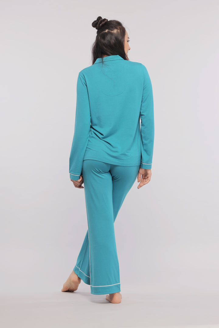 Teal pajamas with white piping, stylish and comfortable for lounging.