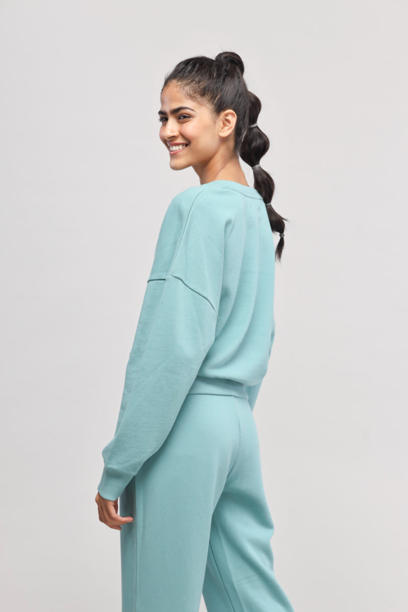 Model wearing light blue Bonjour Terry Sweatshirt, showcasing stylish and comfy design.