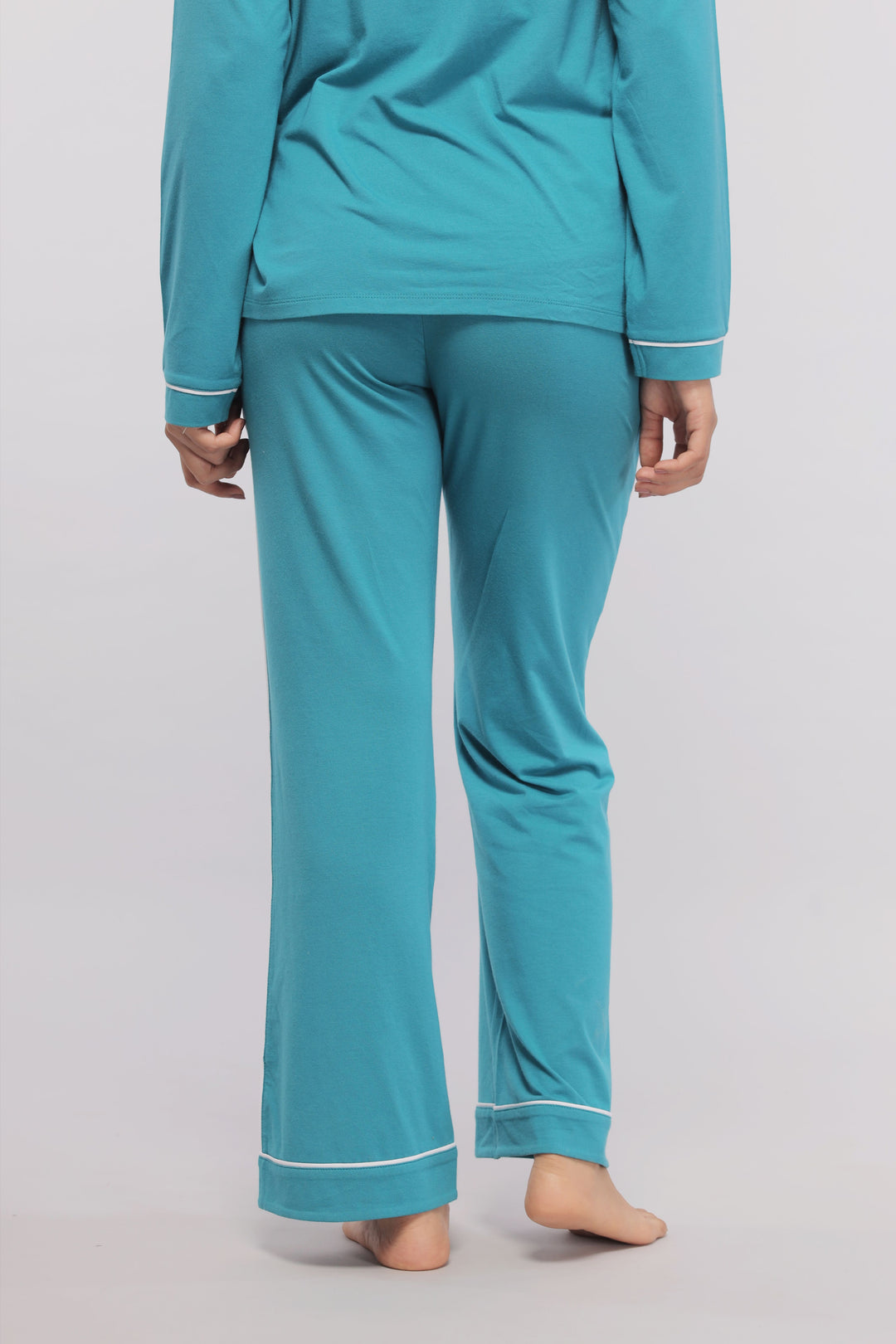 Teal pajamas with white piping, perfect for comfort and style.