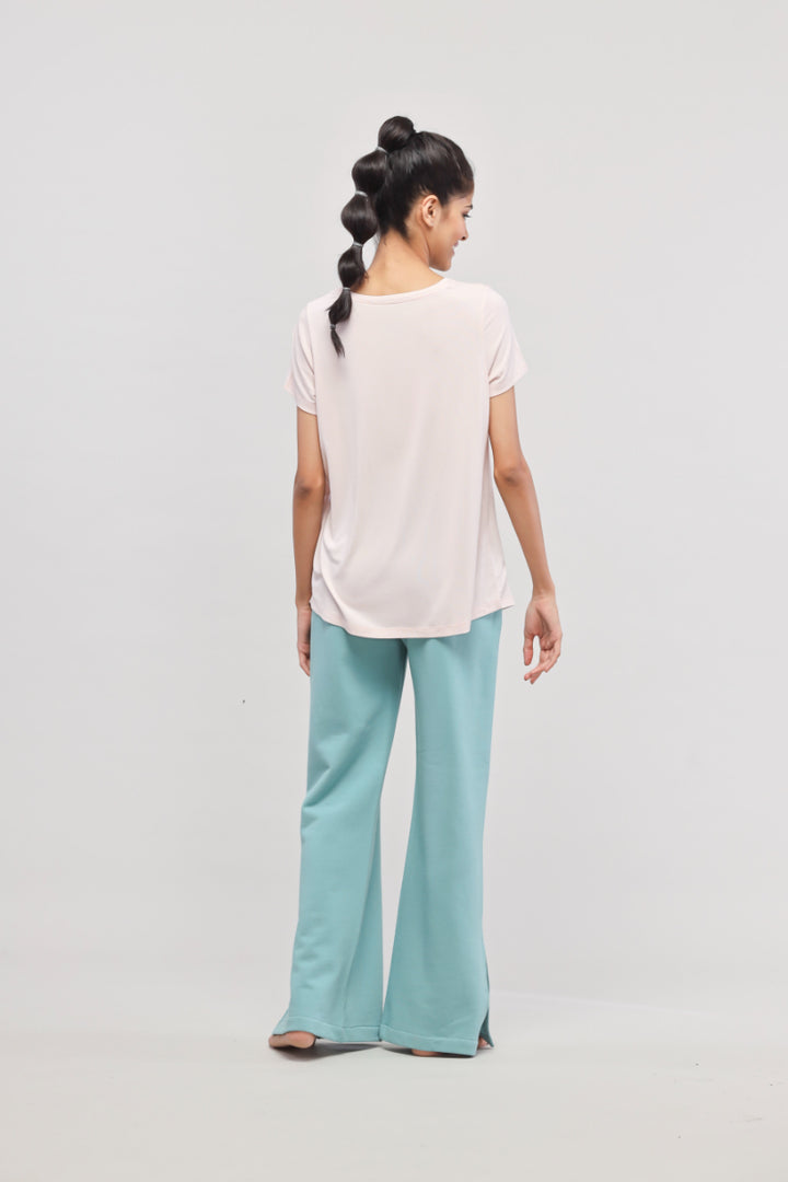 Aqua Terry travel set featuring light pink top and stylish pants.