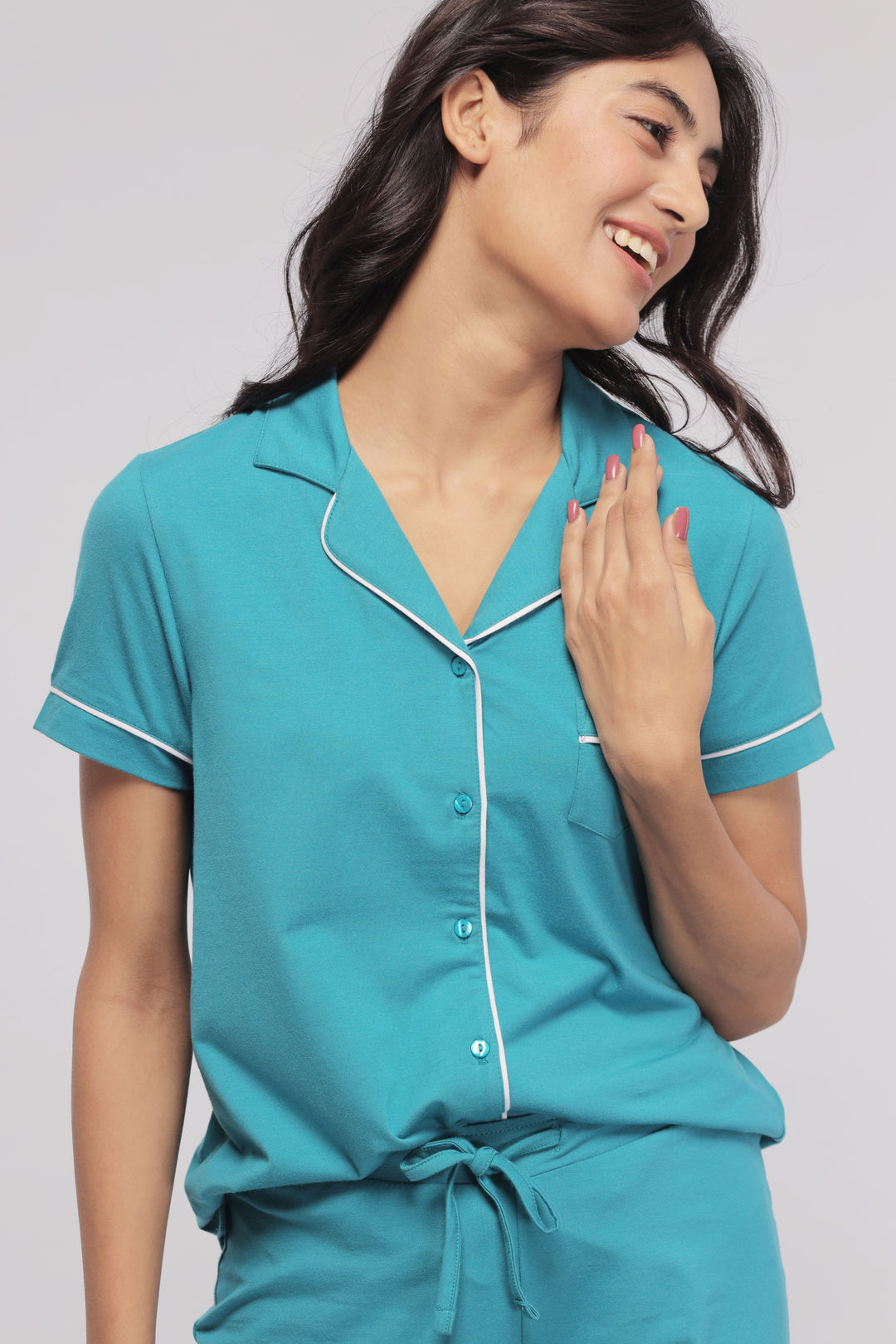 Teal shorts set with white piping, featuring a relaxed button-up shirt.